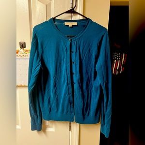 Blue cardigan. No holes or tears